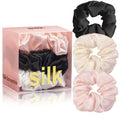 Silk scrunchies in black, white, and pink with packaging labeled 'Silk Scrunchie'.